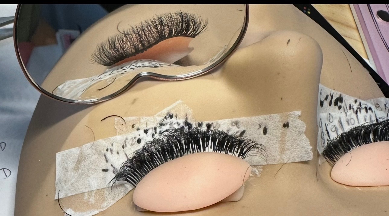 Lash practice strips and precision tools arranged at the artist station